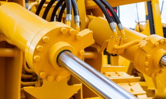 Close up image of hydraulic piston on a yellow goods construction vehicle